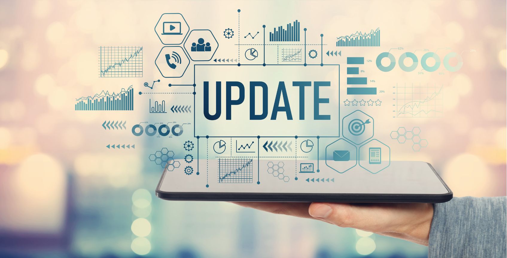 A tablet displays the word UPDATE surrounded by various digital icons and charts, representing data and analytics.