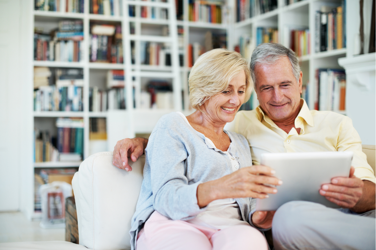 Couple sitting down looking at a device